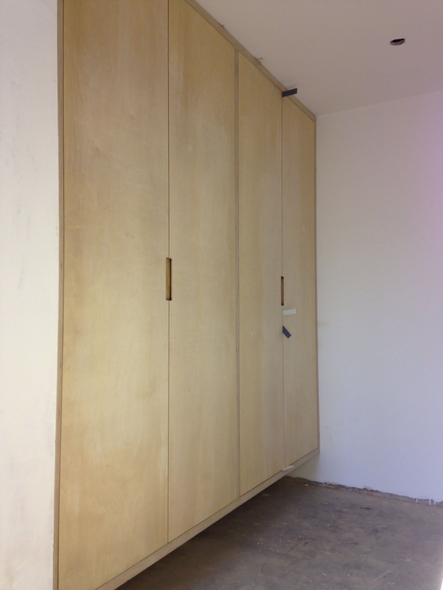 Floating Birch ply wardrobe with integrated handles