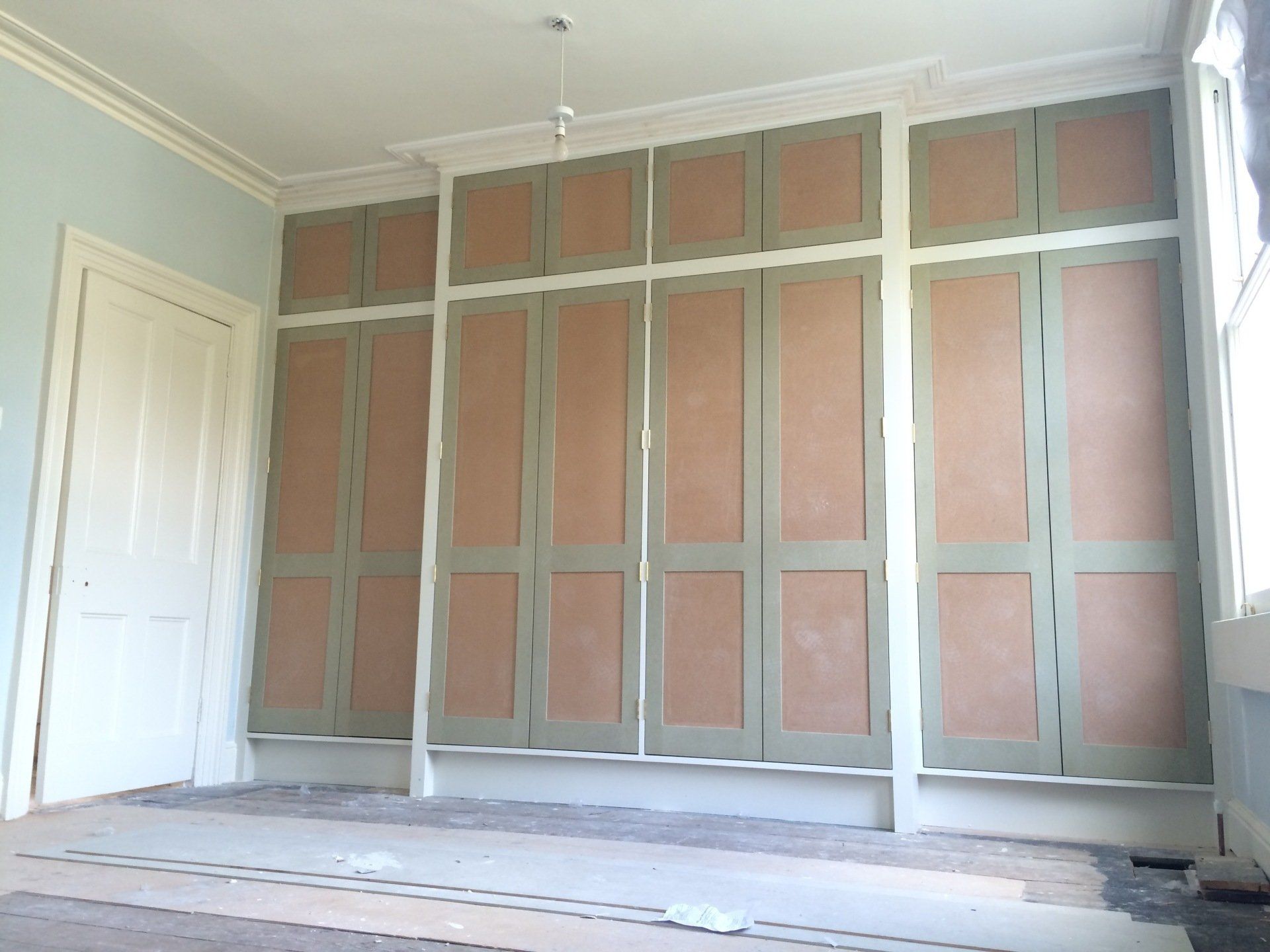 Large shaker wardrobe made from MDF with traditional hinges.