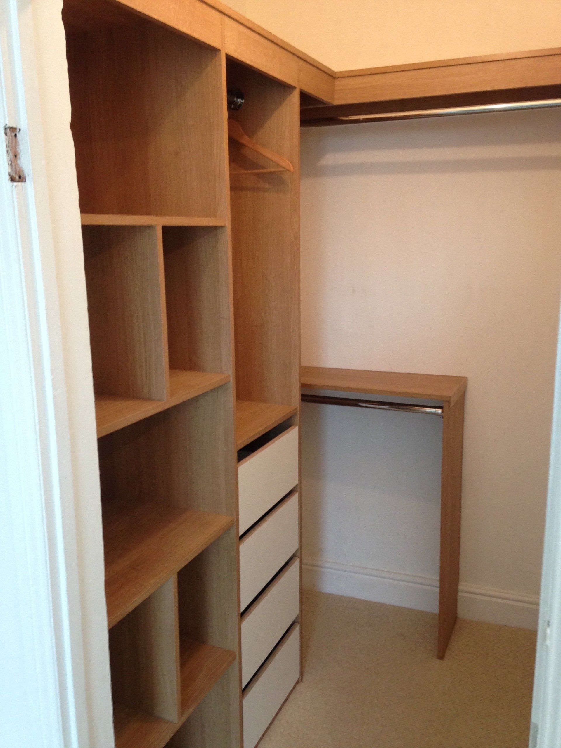 Oak melamine walk in wardrobe with Birch ply drawers and chrome hanging rails.