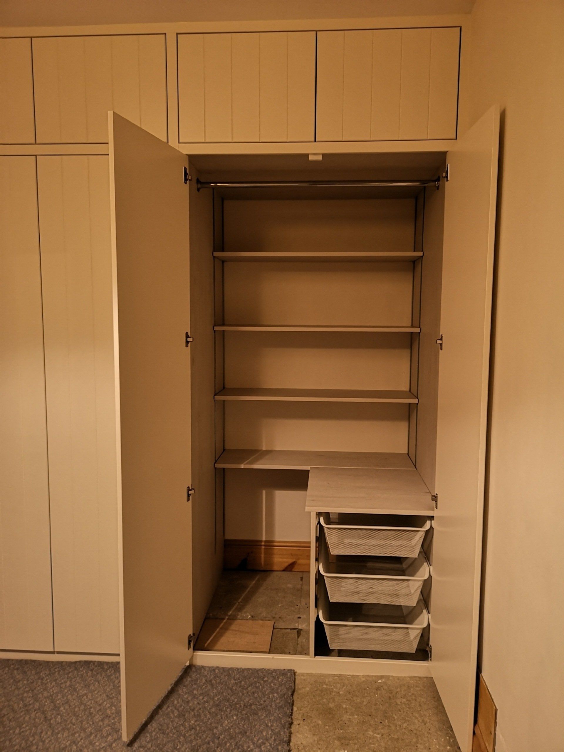 V groove style fitted wardrobe, painted white with smaller doors at the top.