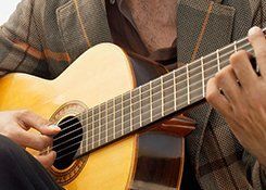 A man playing an acoustic guitar