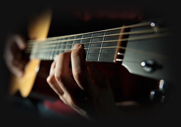 A man playing an acoustic guitar