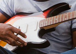 A man holding a bass guitar