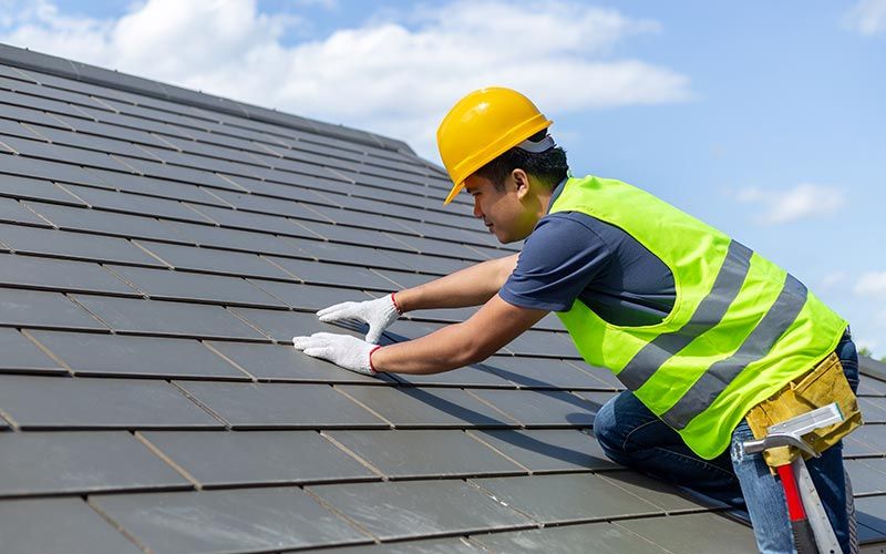 Pitch Roofing — Worker With White Gloves Replacing Gray Tiles in Hyattsville, MD