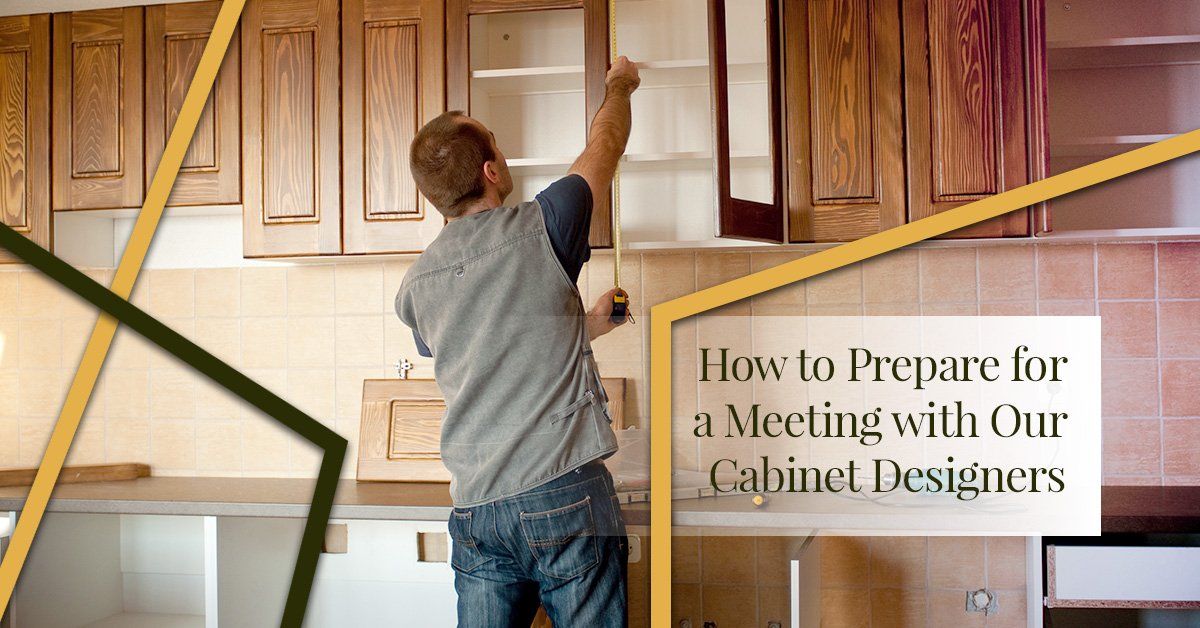 A man is measuring a cabinet in a kitchen.