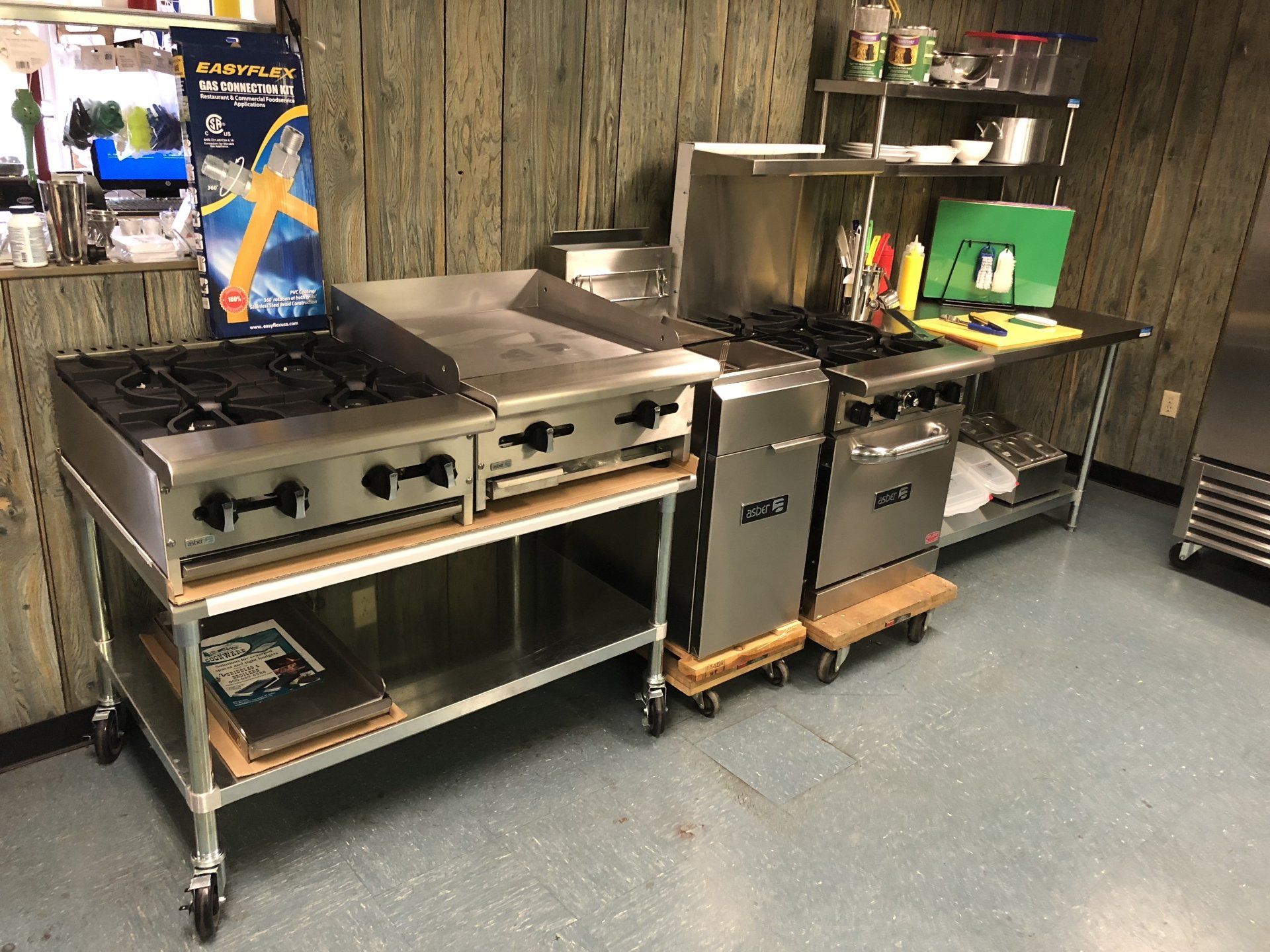 A kitchen with stainless steel appliances including a stove and a refrigerator