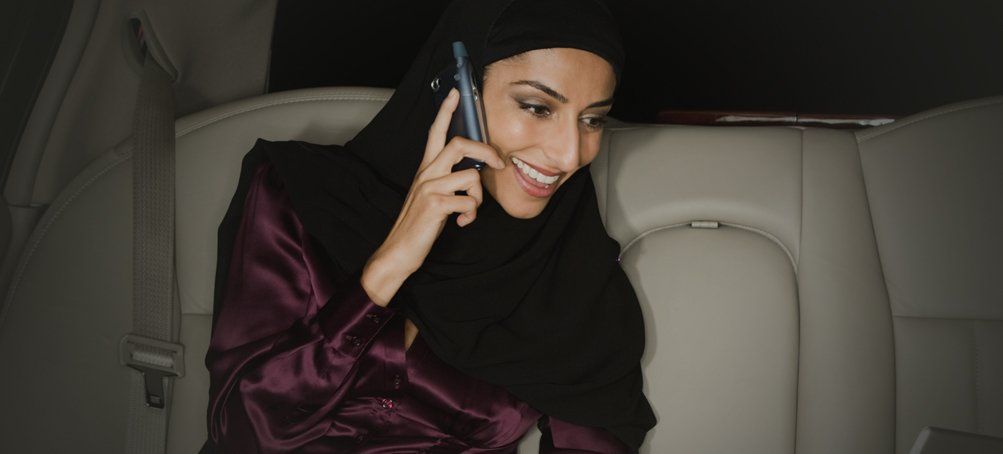 Lady inside the car, answering the phone