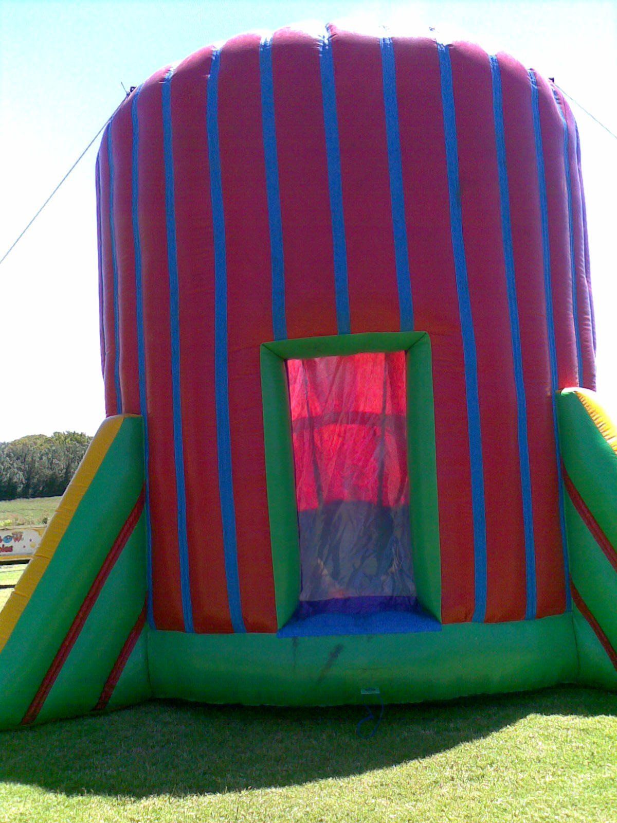 A colorful bouncy house is sitting in the grass