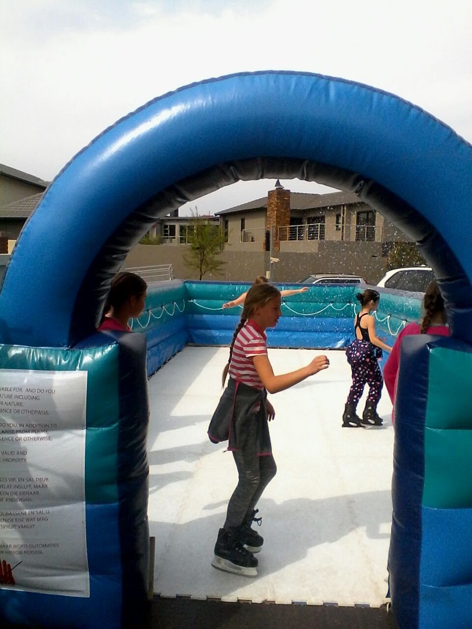 A group of children are ice skating on an inflatable rink