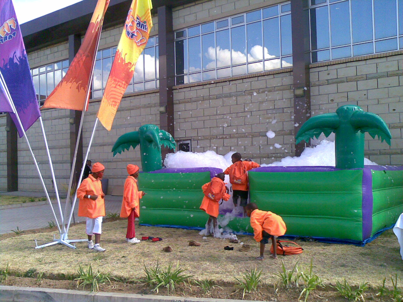 A group of children are playing in a foam filled bouncy house