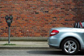 Brick Wall and Silver Car