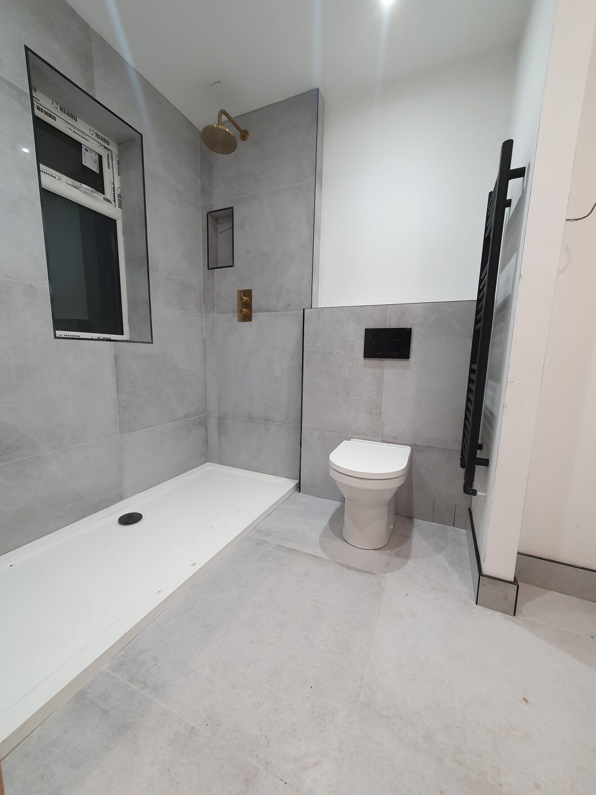 Bright white bathroom with bath, toilet and walk-in shower.