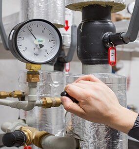 Technician checking water pressure — Well Cleanouts in Tionesta, PA Technician checking water pressure — Well Cleanouts in Tionesta, PA