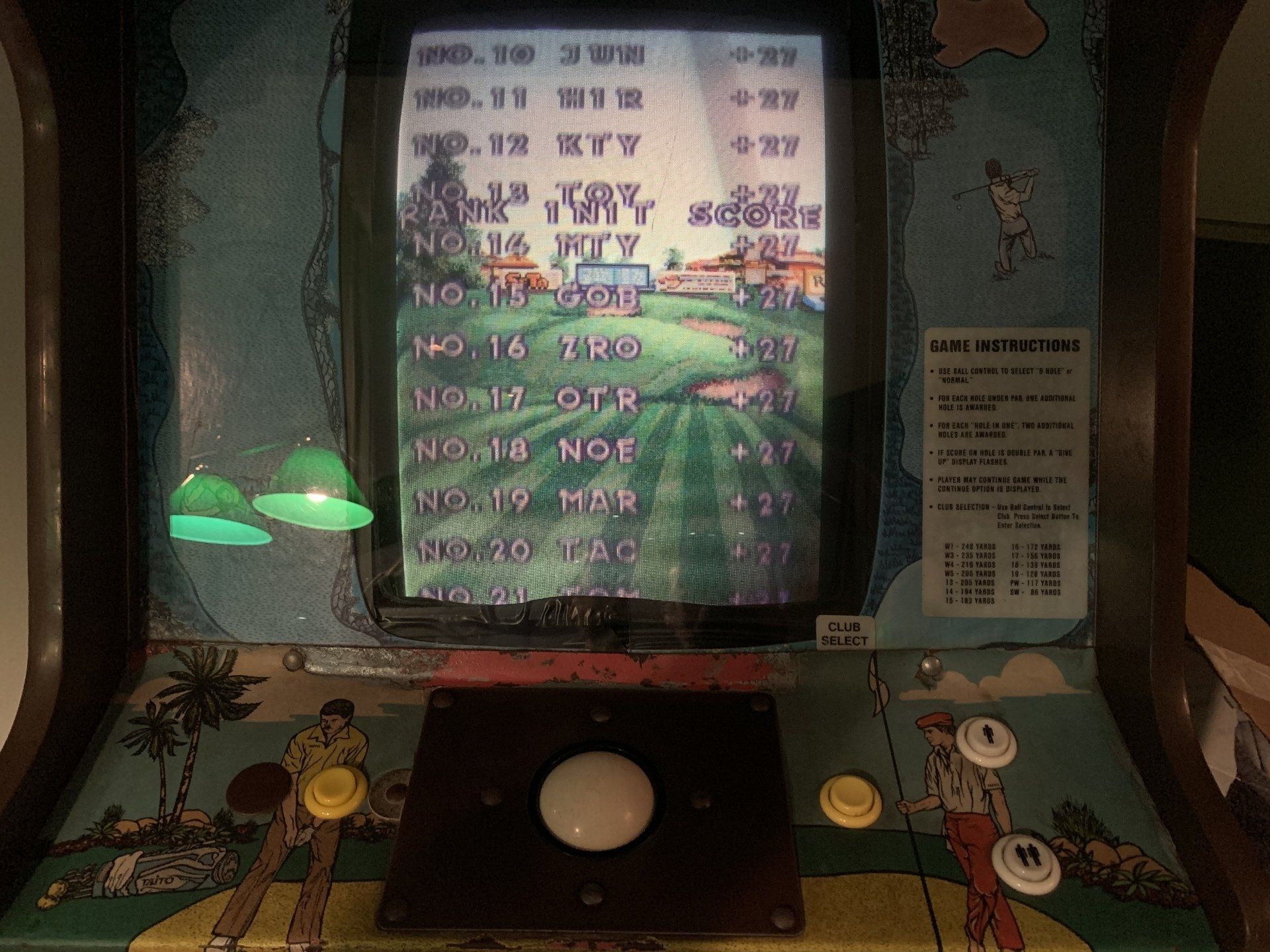 Arcade golf game cabinet with screen displaying a golf course, controls include a trackball and buttons.