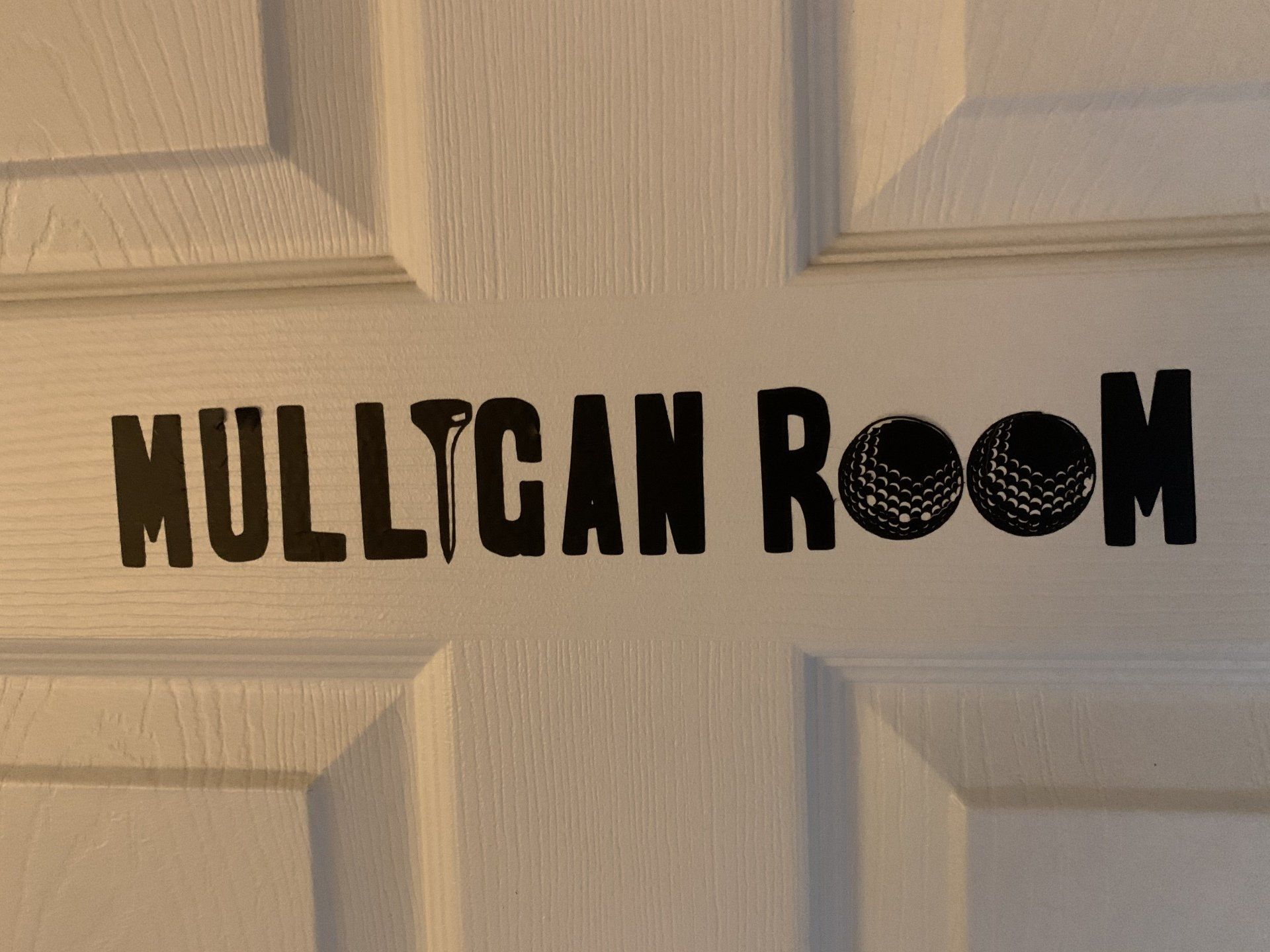 Black text on white door reads 