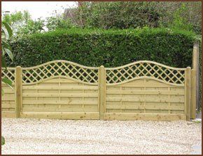 fence with trellis detailing infront of green hedging
