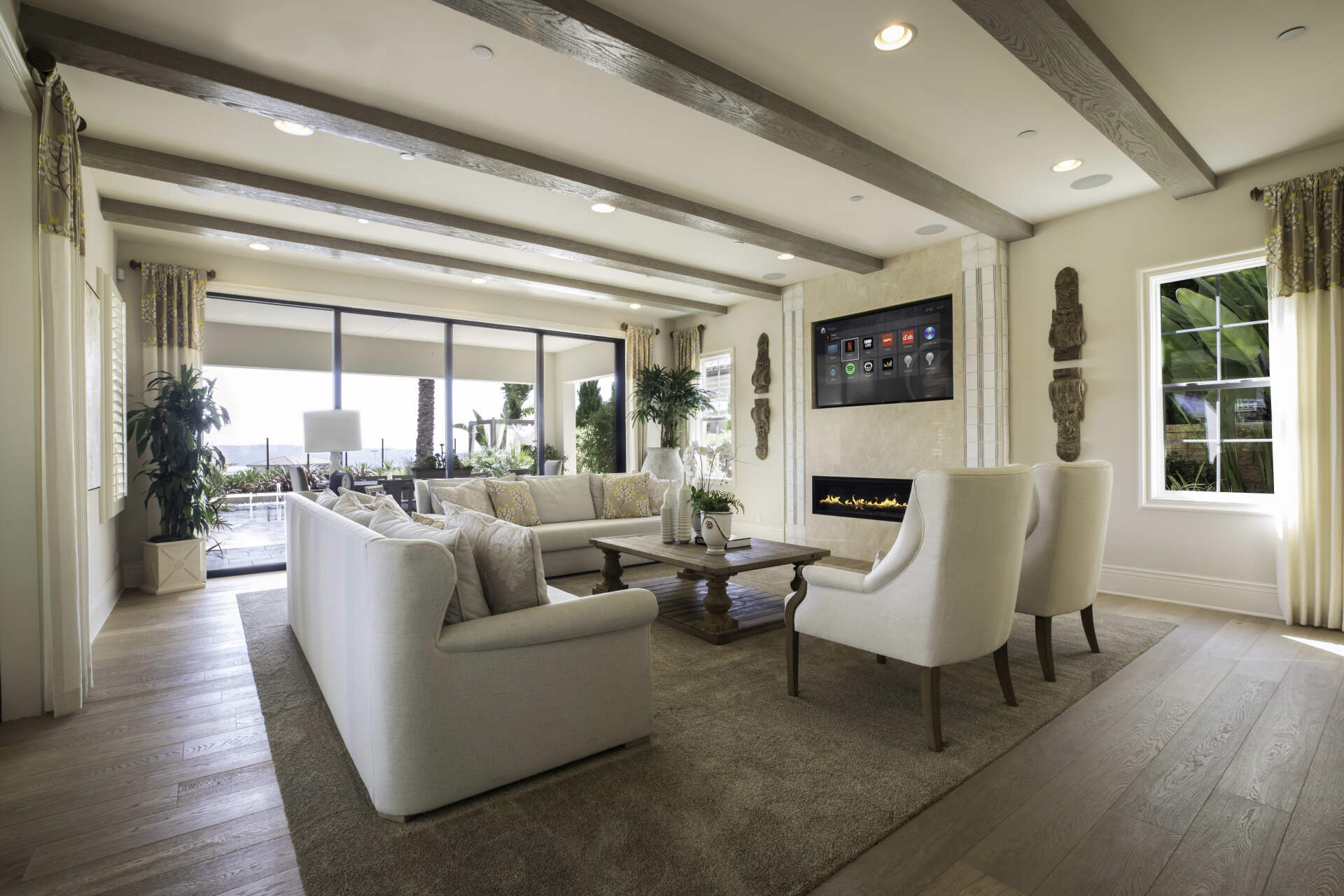 A living room with a couch , chairs , coffee table and television.