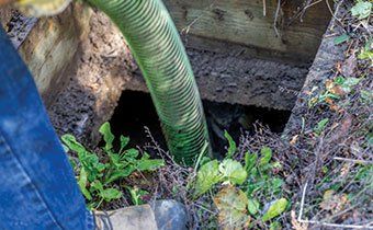 Worker Emptying Septic - Septic Tank Pumping in Astoria, Oregon Worker Emptying Septic - Septic Tank Pumping in Astoria, Oregon