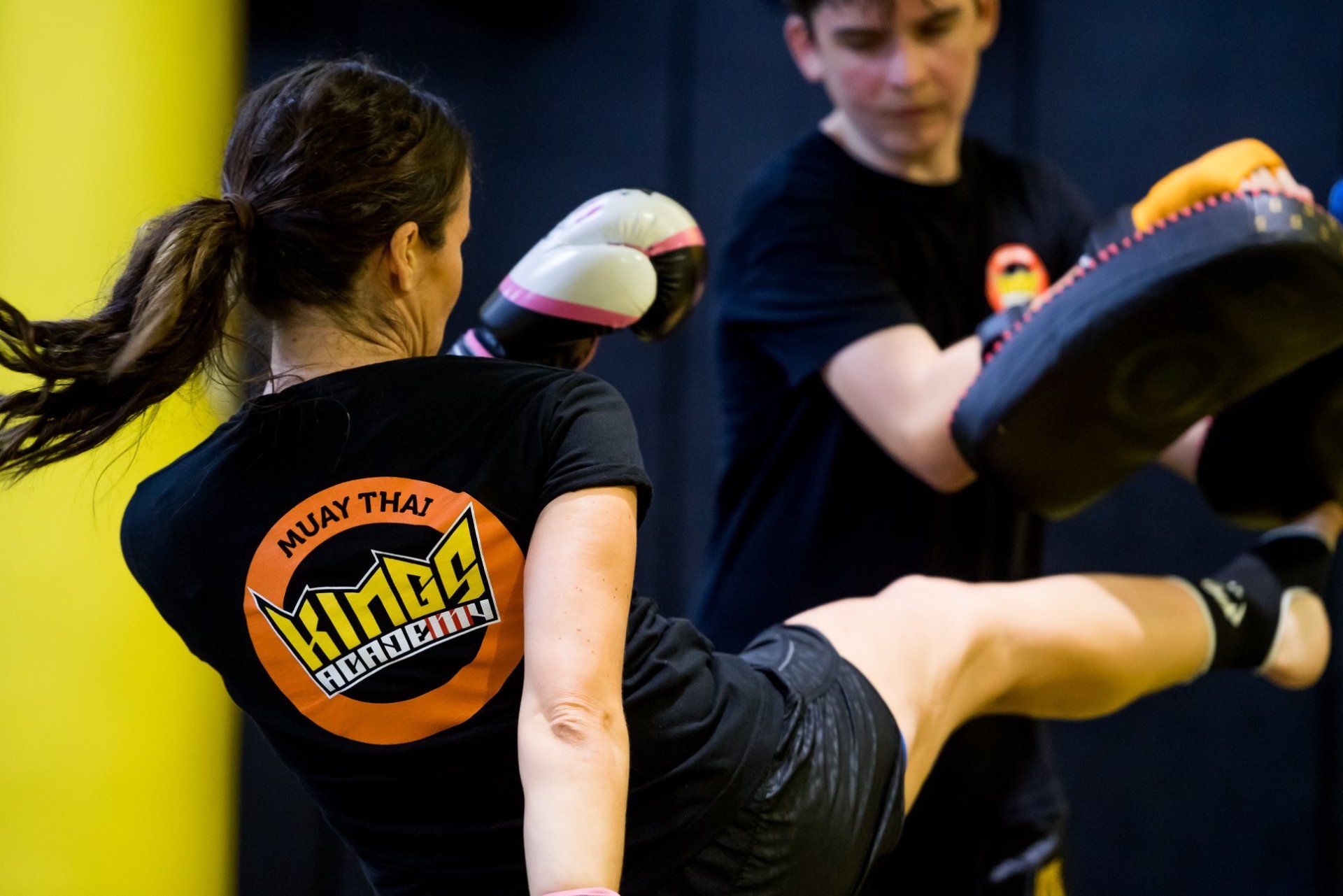 Muay Thai Kickboxing students practicing kicks on Thai pads at Kings Academy Sydney