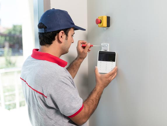 Man Installing Security Alarm System — Sonbert Security Systems Inc. — Winston Salem, North Carolina Man Installing Security Alarm System — Sonbert Security Systems Inc. — Winston Salem, North Carolina