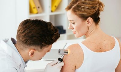Dermatologist Checking Woman's Skin — Charleston, WV — H. Richard Reynolds, M.D. Dermatologist Checking Woman's Skin — Charleston, WV — H. Richard Reynolds, M.D.