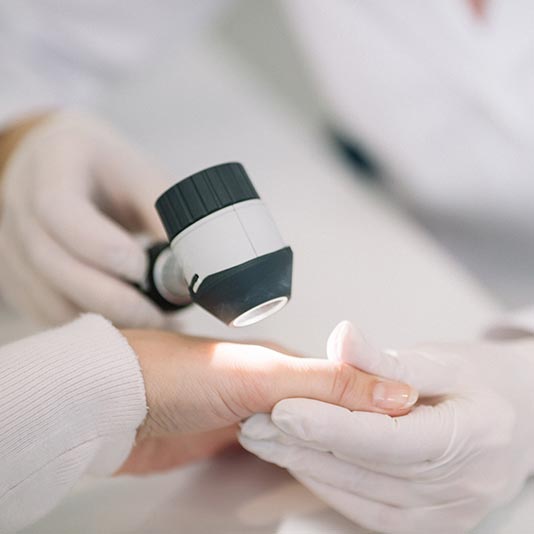 Doctors Examining Patient's Hand — Charleston, WV — H. Richard Reynolds, M.D.