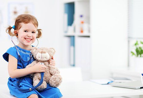 The Clinic of Pediatrics and GI Medicine — Child Smiling with Stuffed Toy in Panama City, FL The Clinic of Pediatrics and GI Medicine — Child Smiling with Stuffed Toy in Panama City, FL