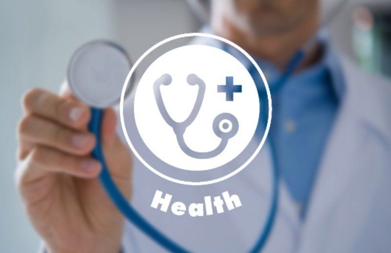 Doctor holding stethoscope with health icon and the word “Health” overlayed on screen