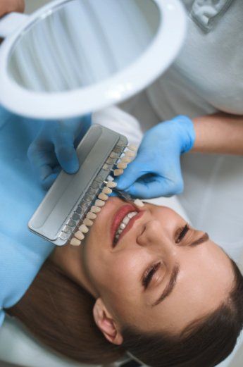 woman receiving dental veneers for comparison to her teeth whiteness.