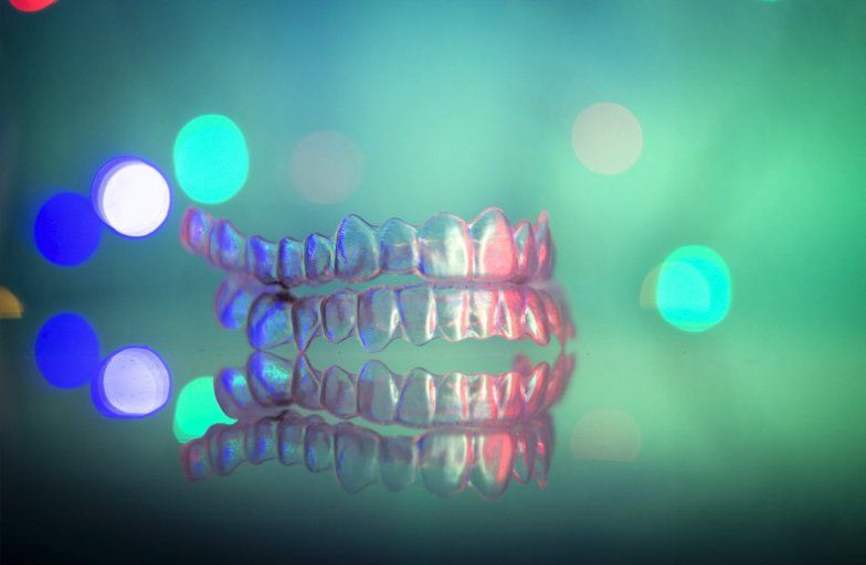 Invisalign retainers on a neon light background in Brighton Beach during the Christmas holidays in Brooklyn NYC