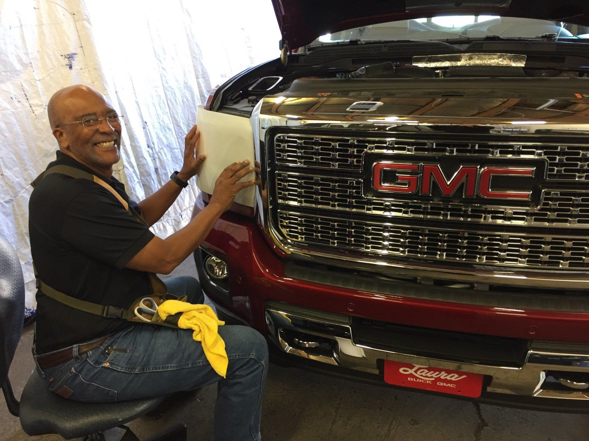 Paul Hasty is sitting in front of a red gmc truck.