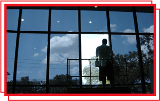 man doing window tinting on commercial building near colorado springs