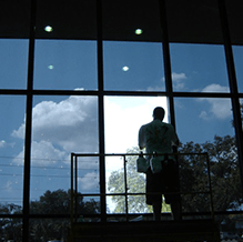 man doing window tint installations in a commercial building near colorado springs