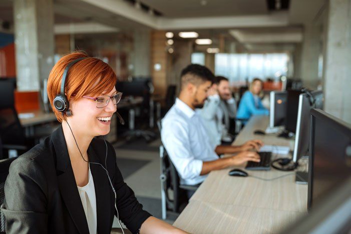 Woman with red hair wearing a headset — Mission, KS — AIH Receivables Woman with red hair wearing a headset — Mission, KS — AIH Receivables