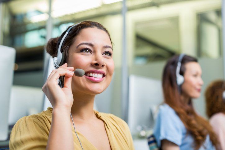 Woman holding the microphone of her headset — Mission, KS — AIH Receivables Woman holding the microphone of her headset — Mission, KS — AIH Receivables