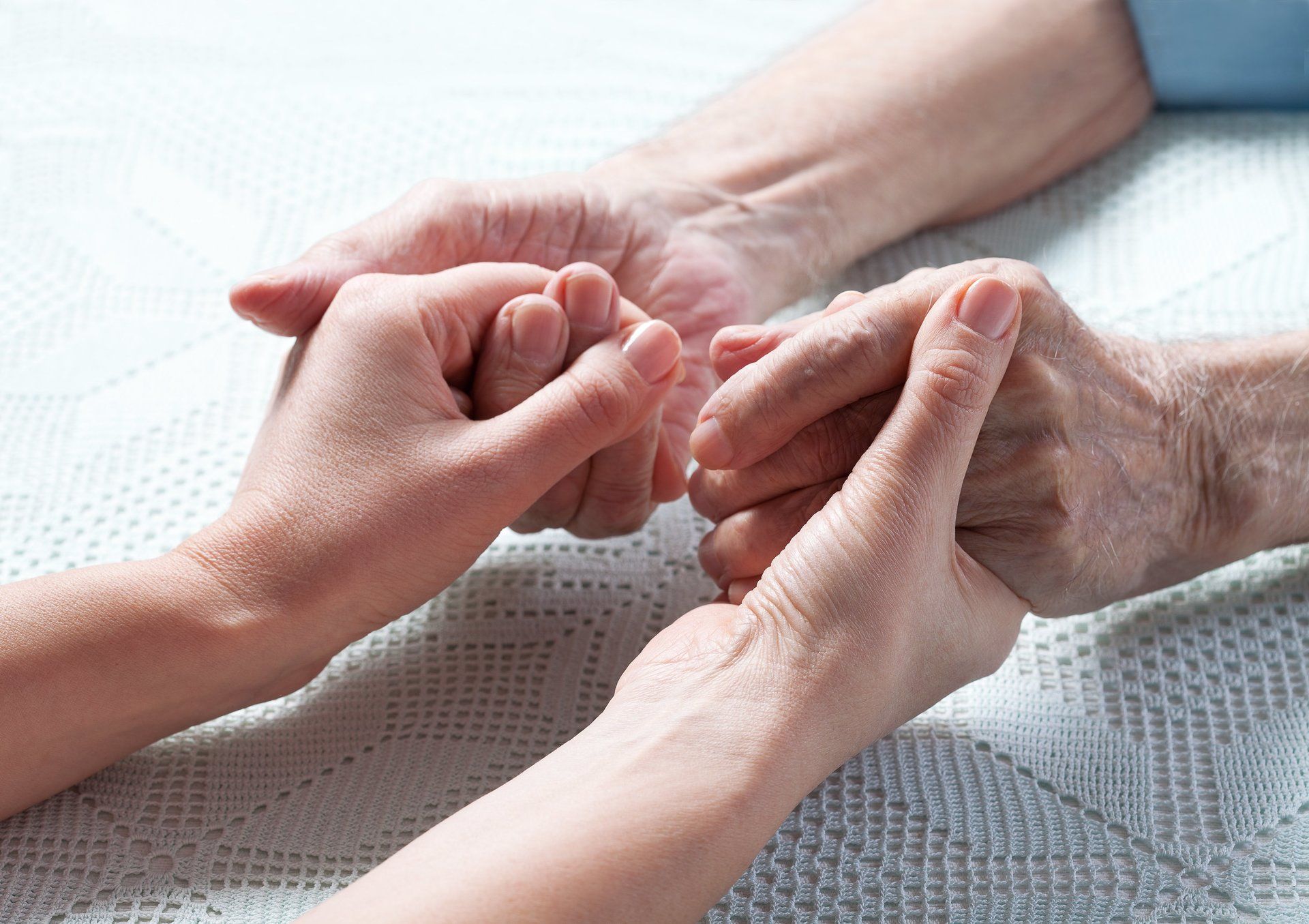 Senior holding hands