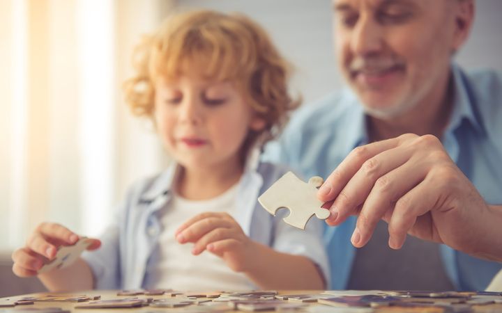 Senior with grandchild and puzzle