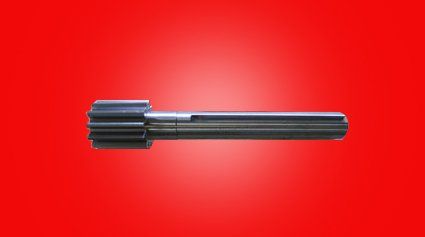 Steel gear shaft with cylindrical body, on a red background.