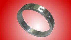 Metal ring with several holes, on a gradient red background.