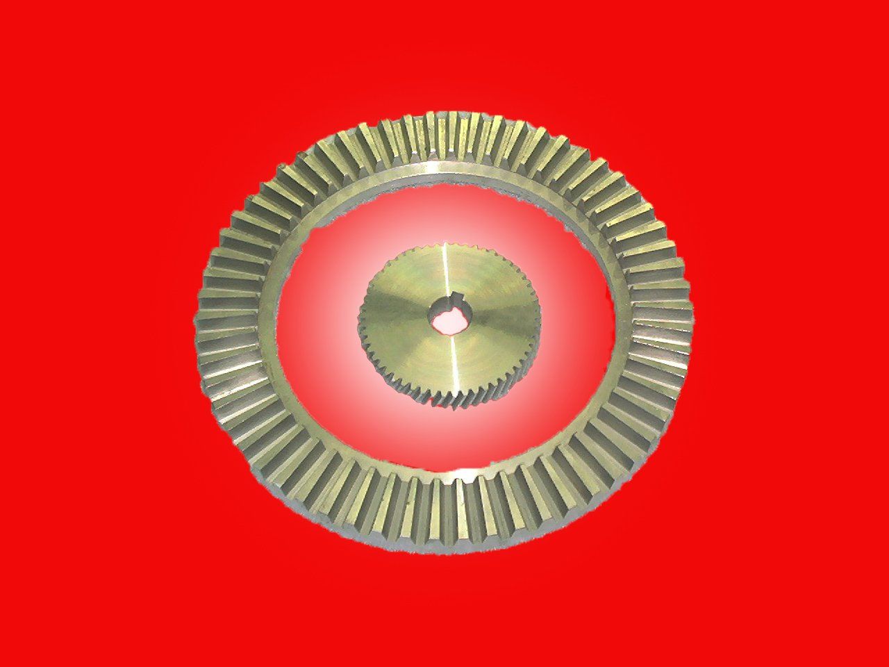 Two beveled gears on a red background, one small and one large, nested.