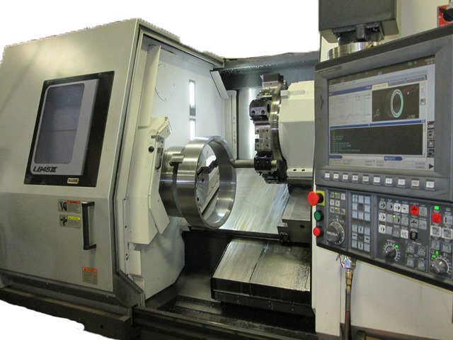 CNC lathe machine machining a large metal ring, with control panel visible.