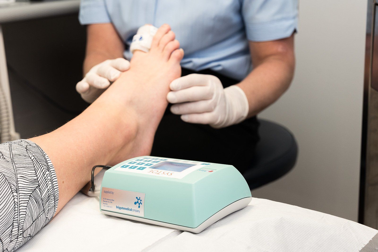 Doctor holding a foot with a scale
