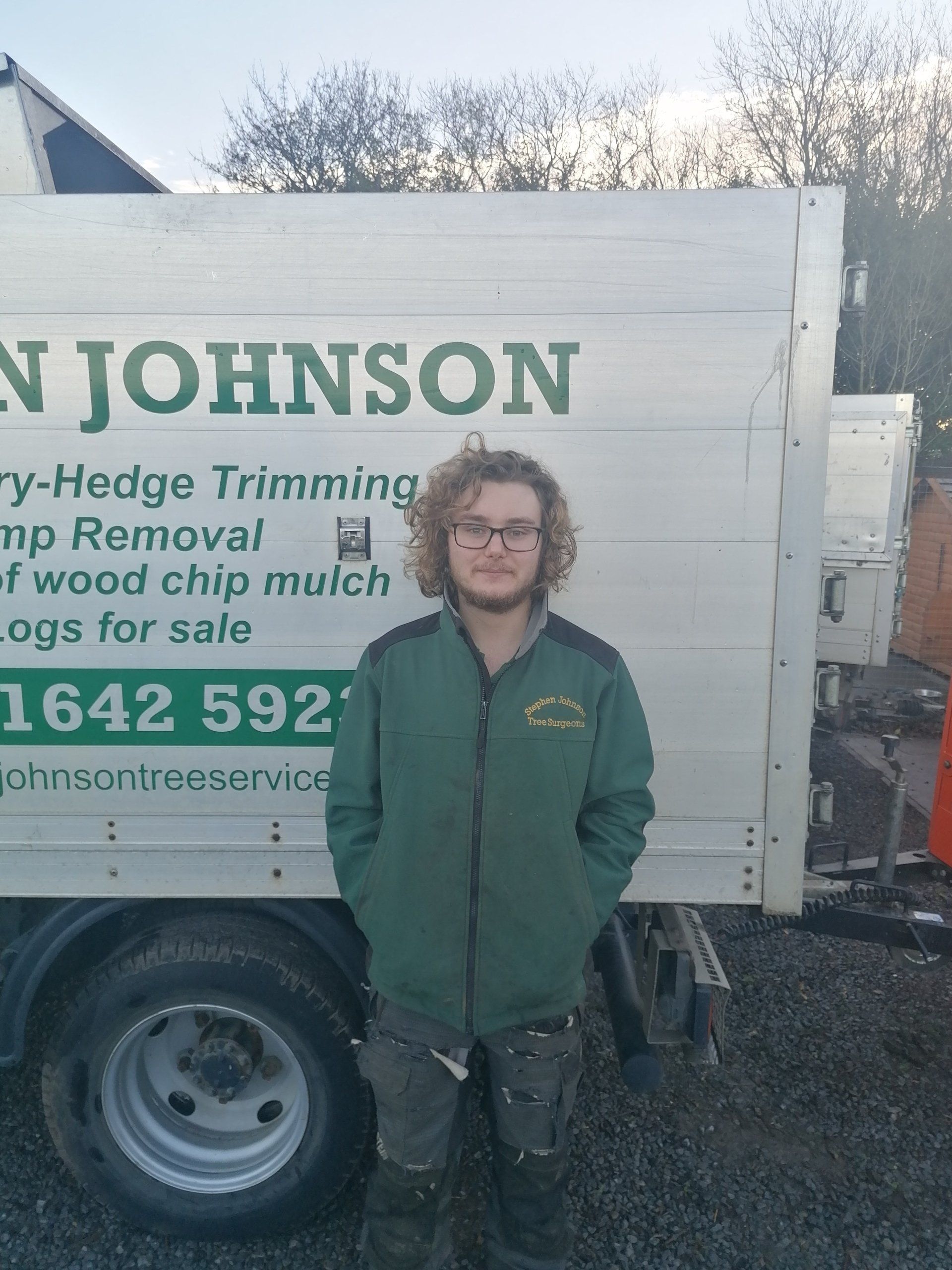A man standing in front of a truck that says johnson