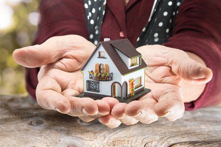 Old Woman Holding a Miniature House — Pittsfield, MA — Drennan Law Offices