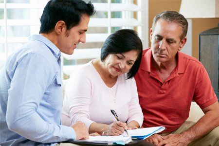 Couple Signing a Paper With the Attorney — Pittsfield, MA — Drennan Law Offices