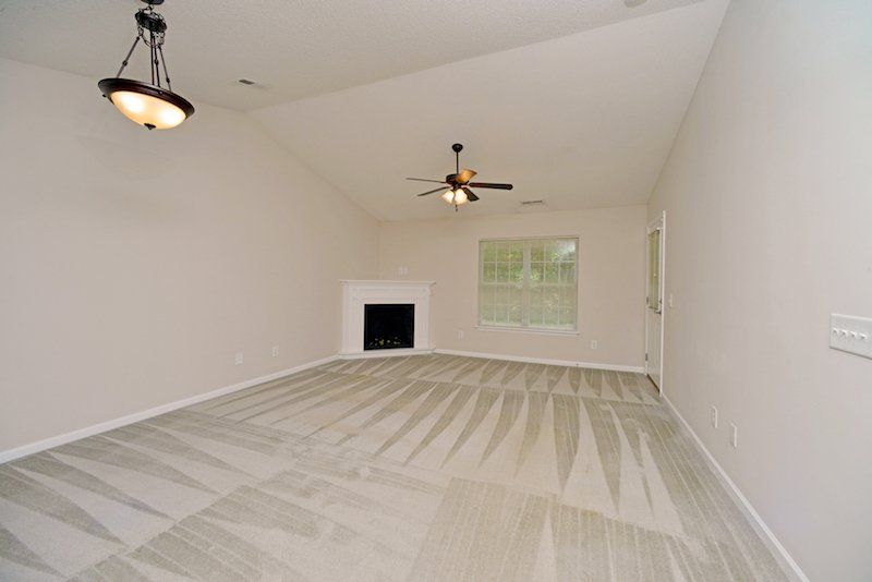 beacon living room and dining room. Corner fireplace. Cathedral ceilings. Ceiling fans.
