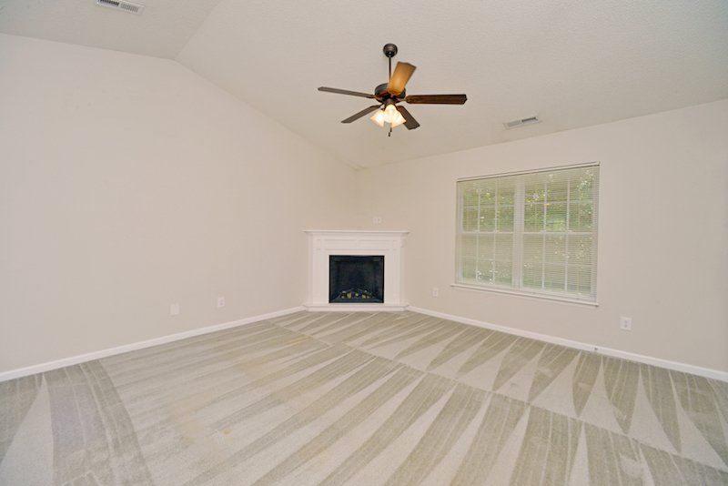 beacon living room and dining room. Corner fireplace. Cathedral ceilings. Ceiling fans.