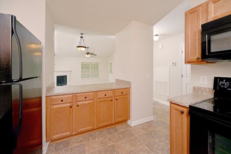 beacon kitchen with brown cabinets and black appliances