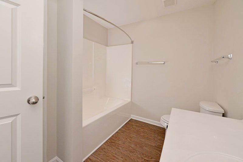 beacon guest bathroom view with the shower, partial counter, and toilet