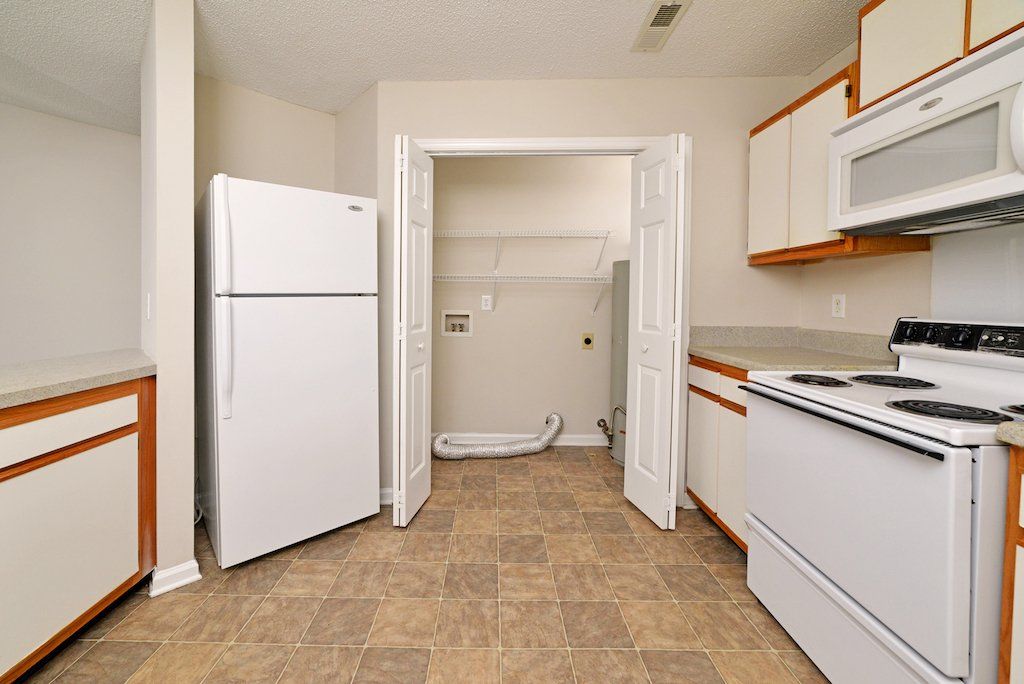 pinnacle kitchen 2-toned cabinets with view of the laundry rooms